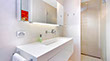 A white  bathroom with clean lines is part of the renovation at the Surf View apartments in Mona Vale